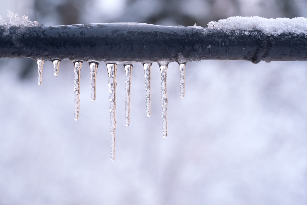 frozen outdoor pipe with icicles hanging off